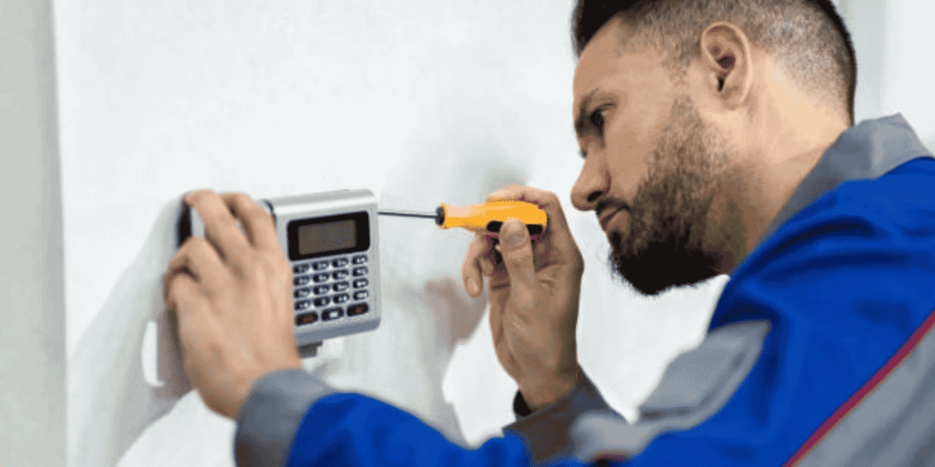 Professional installer working on a modern alarm system