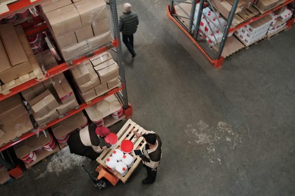 High angle view of warehouse workers handling inventory and logistics operations.