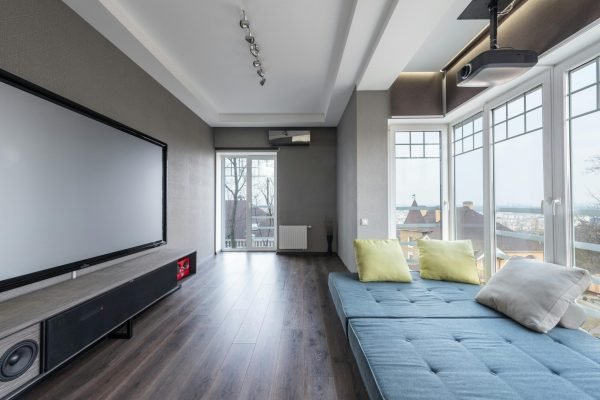 pexels-photo-7031762-7031762 Comfortable settee with colorful cushions placed near big windows against contemporary television set in spacious room of modern stylish apartment